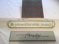 All three wooden signs laid out
