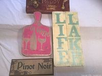 All four wooden signs laid out