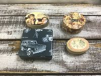 All four small boxes displayed on wooden surface