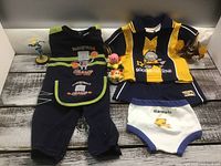All items together: soccer outfit, basketball onesie, four toys