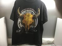 Front view of T-shirt showing bull skull and truck graphic