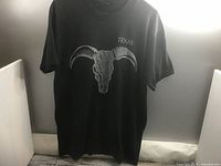 Front of black t-shirt displaying ram skull graphic and Texas text