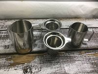 Both stainless steel strainers with accompanying vessels visible