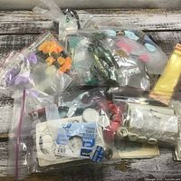 Bags of embroidery floss and sewing notions overview