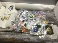 Overview of all embroidery floss bags, aida cloths, and waste canvas pack on tabletop