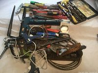 Assorted tools spread on surface, shows majority of lot