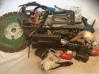 Entire lot of tools including large green segmented saw blade and staple gun