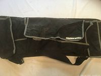Full view of folded TrunkWhiz organizer showing pockets and strap