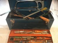 Overall view of blue metal toolbox with tools visible in both compartments