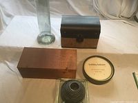 Full lot showing vase, metal box, wood chest, candle tin, glass holder