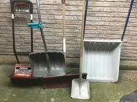 Group shot of all snow removal tools standing against wall
