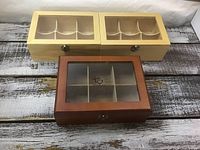 Front view of three sectional wooden boxes showing colors, lids, compartments
