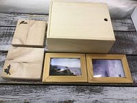 All five wooden pieces lined up: box, two plaques, two frames