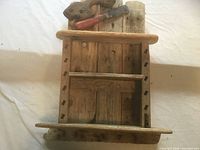 Front view showing full two-tier shelf with attached vintage tool handles