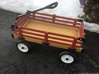 angled view of full wood wagon showing rails, wheels and handle