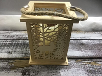 Front view of wood lantern showing deer/tree cutout design