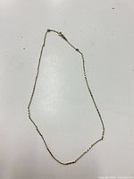 Full view of gold chain laid flat