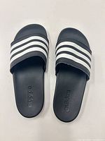 Top view of both Adidas slides showing overall design and branding