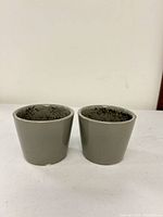 Front view of both gray ceramic planters