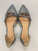 Top view of both flats showing silver holographic upper and D’Orsay cutouts