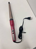 Full view of curling wand with cord and plug