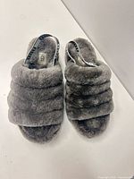Top view of both gray UGG shearling slide slippers