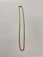 Full view of paperclip chain necklace laid flat