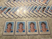 Wide view showing majority of the 30 Red Rooster Oilers cards laid out including four Gretzky variations