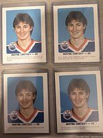Four Wayne Gretzky cards from the set in sleeves
