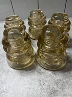 Group of five amber glass insulators