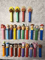 All 24 Pez dispensers arranged by group on tabletop