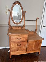 Front view of vanity showing drawers, cabinet, mirror, and harp supports