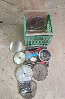 crate containing multiple packaged blades and loose discs