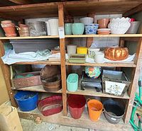 Full shelving showing assorted pots on three levels