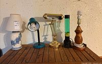 Group shot of all five lamps on wooden surface