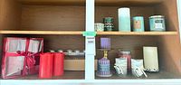 Full view of cabinet shelves showing entire assortment of candles