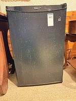 Front view of black Danby mini fridge closed