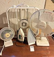 Group shot of all three fans and two steam irons