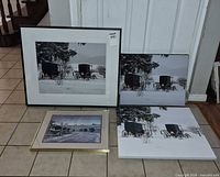 Four framed or mounted prints laid out for size comparison