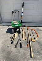 Group shot of all tools laid out including spreaders, axes, saws, shears, tree-pruner