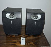 Front view of both Bose speakers on table