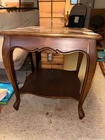 Front view showing legs, apron and lower shelf