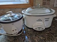 Rival slow cooker and Durabrand rice cooker side by side on countertop
