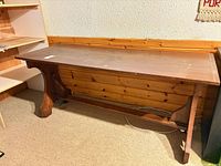 Full view of wooden trestle table front angle