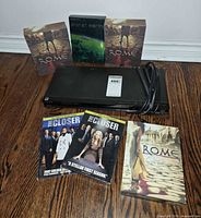 Sony DVD player with cables and all DVD box sets displayed