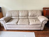 Front view of beige three-seat sofa