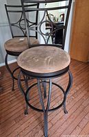 Both metal swivel bar stools showing full view