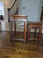 Side profile of both rosewood tables showing size difference and leg design