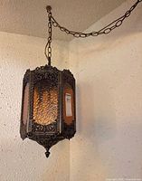 Full view of hanging swag lamp on chain