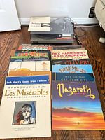 Technics SL-23 turntable with dust-cover and RCA leads, vinyl LPs fanned in front